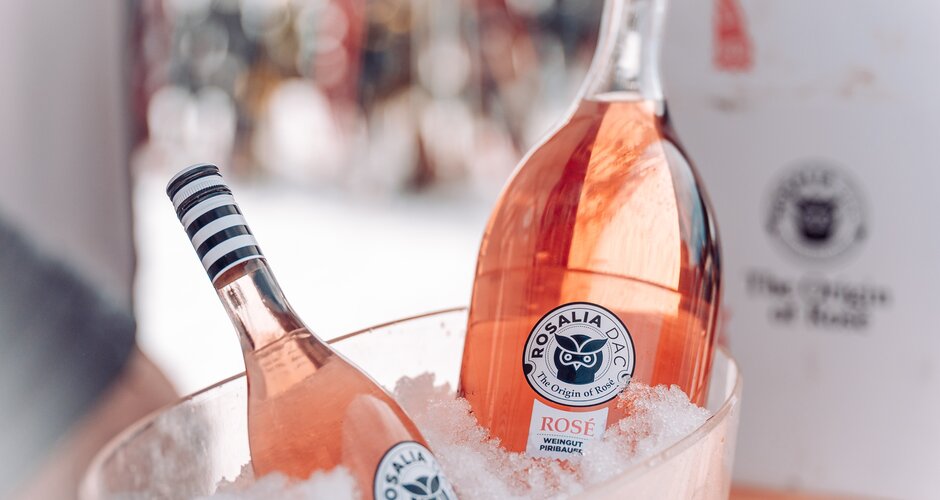 Two bottles of Rosalia DAC rosé wine are placed in a clear ice bucket filled with crushed ice