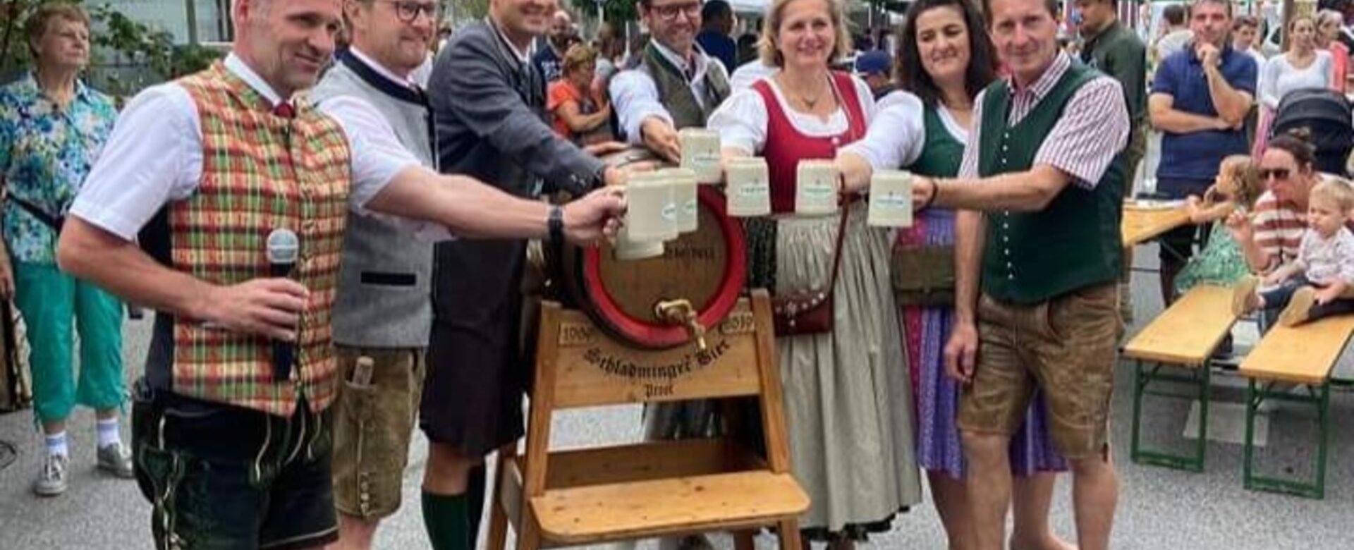 Beer tapping at Altsteirer Kirtag with traditional dress and mountains