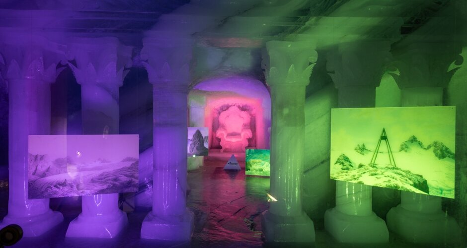 Colorfully lit ice palace with ice columns, photo art and sculptures in a mystical exhibition atmosphere. | © Harald Steiner