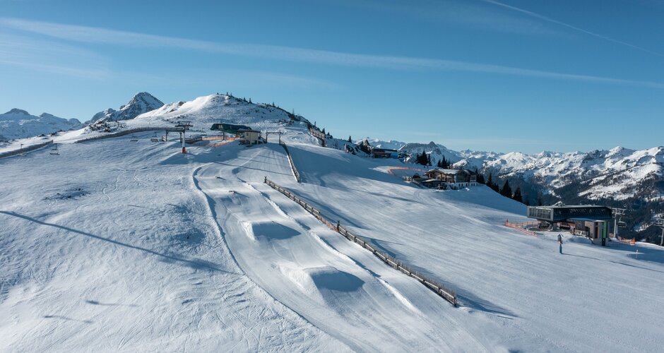 Drone image of a piste landscape with snow jumps