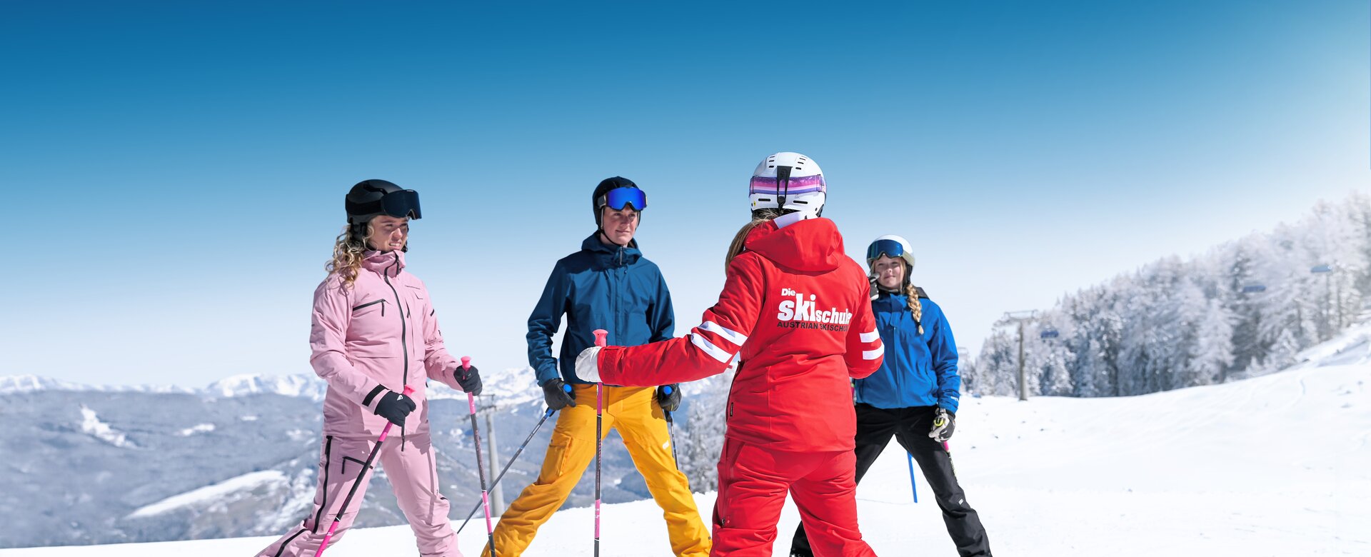 Ski instructor teaches four students in colourful outfits on sunny, snowy slope in Ski amadé